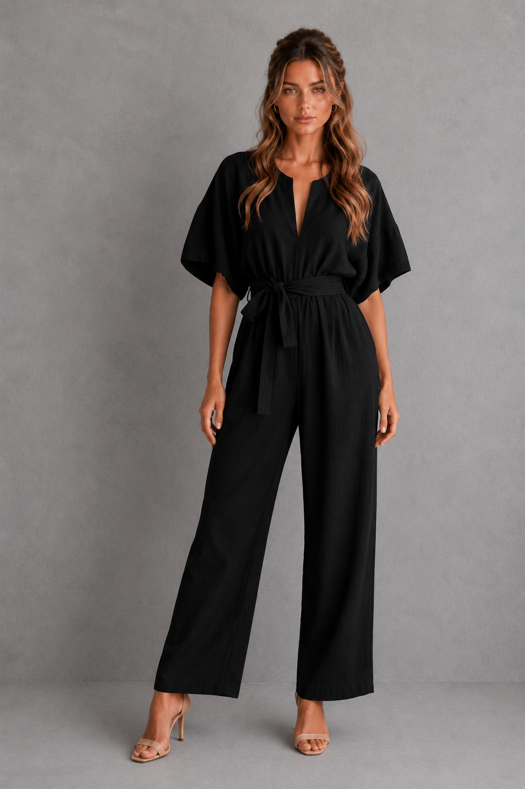 Women’s linen blend wide leg jumpsuit with V-neckline, half sleeves, lace-up waist, and relaxed flowing silhouette.