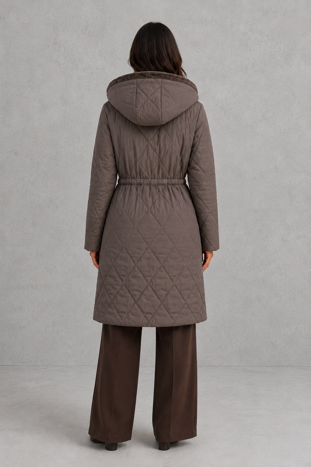 Women’s long quilted puffer coat with diamond stitching, a plush faux fur collar, adjustable drawstring waist and practical front pockets.