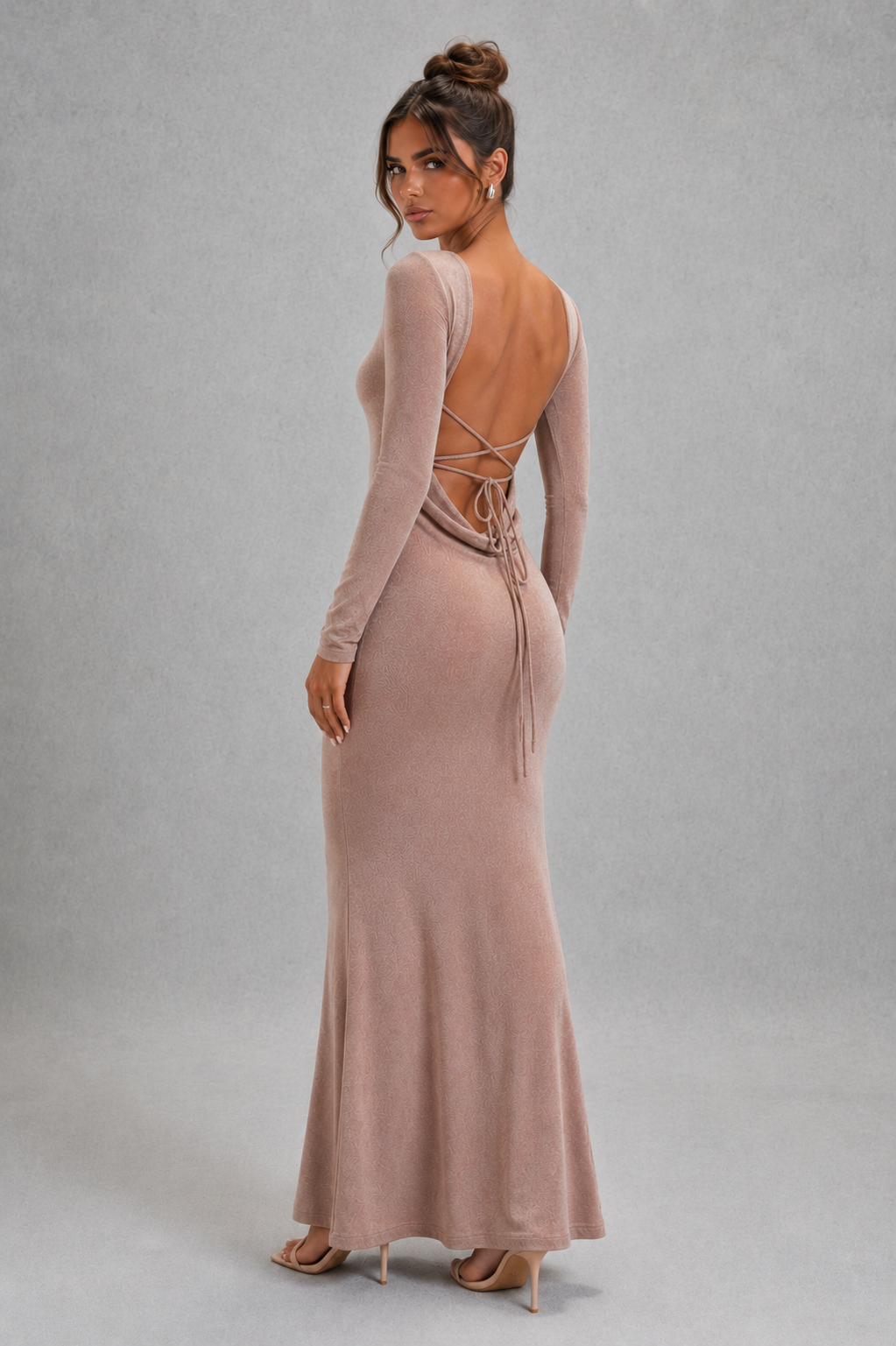 Women's long sleeve bodycon maxi dress in premium stretch fabric featuring a figure-hugging silhouette, dramatic low open back with adjustable tie detail, and elegant floor-length design for evening parties, formal events, and special occasions.
