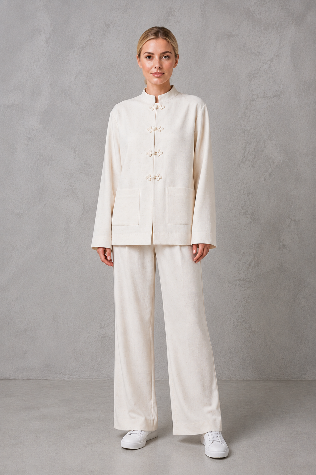 Women’s mandarin collar blazer with a sleek stand collar, streamlined front closure, structured woven fabric, and relaxed tailored silhouette.