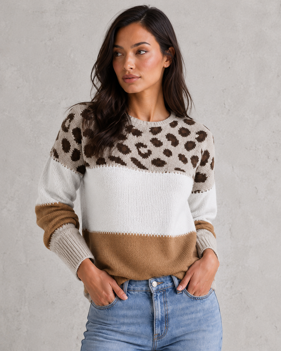 Woman wearing a mixed-pattern knit jumper with a relaxed fit and long sleeves, styled for a modern casual-chic look.
