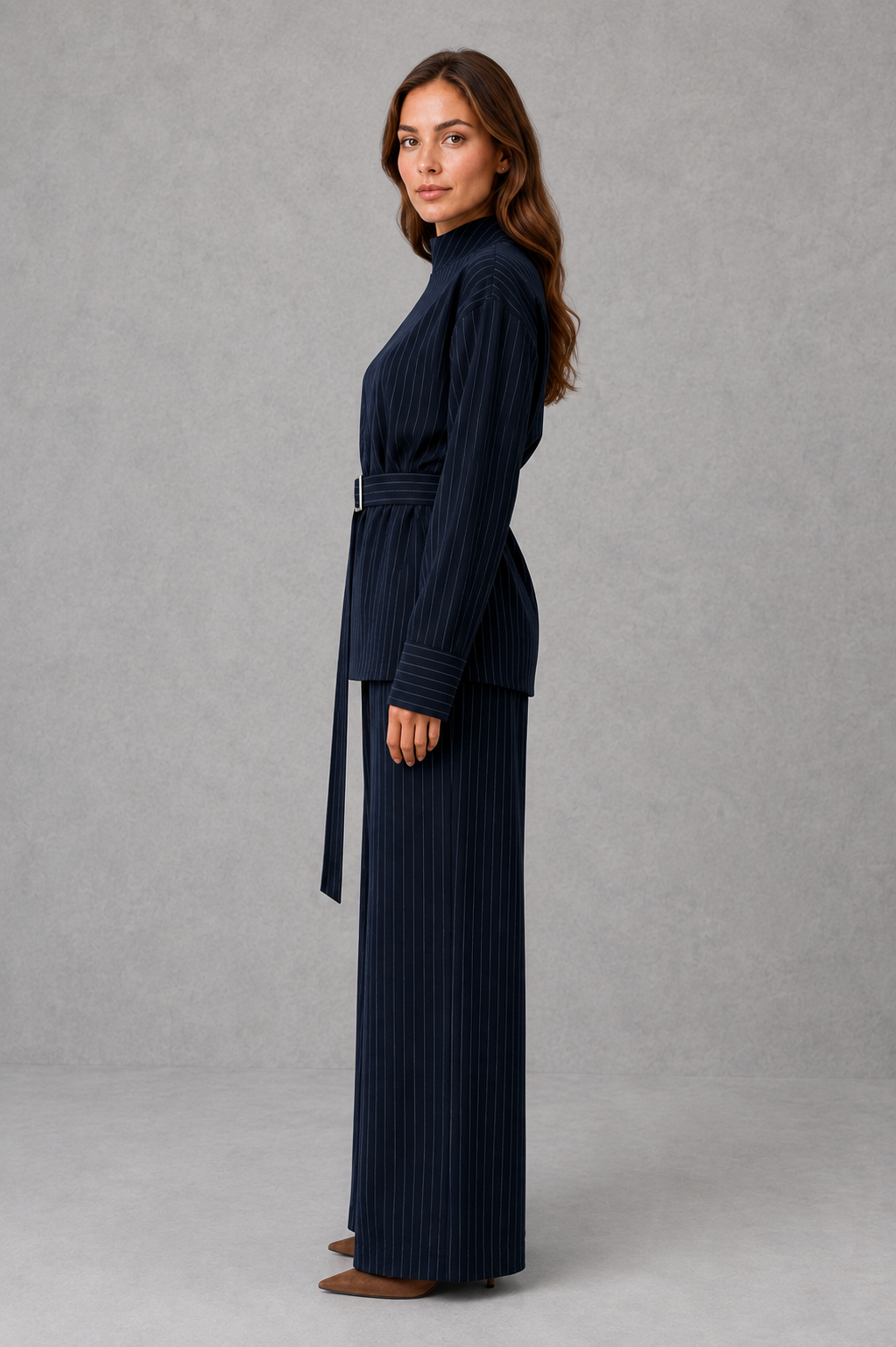 Women’s navy pinstripe two-piece set featuring a long-sleeve high-neck top with a belted waist and matching wide-leg pants.