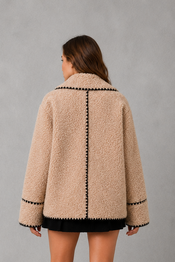 Women’s open-front sherpa fleece jacket with a soft teddy-style texture, turn-down collar, relaxed fit, and subtle contrast detailing.