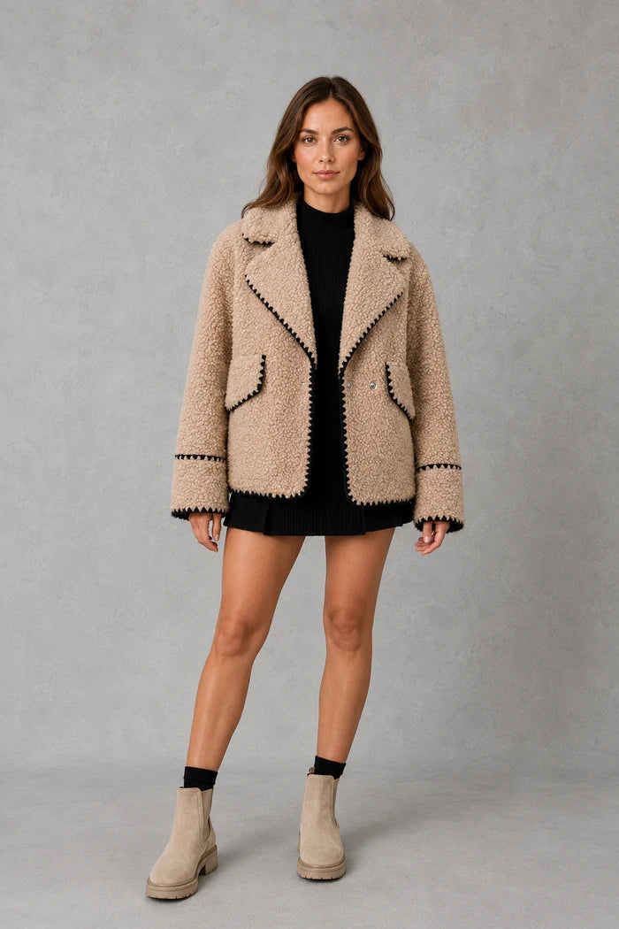 Women’s open-front sherpa fleece jacket with a soft teddy-style texture, turn-down collar, relaxed fit, and subtle contrast detailing.