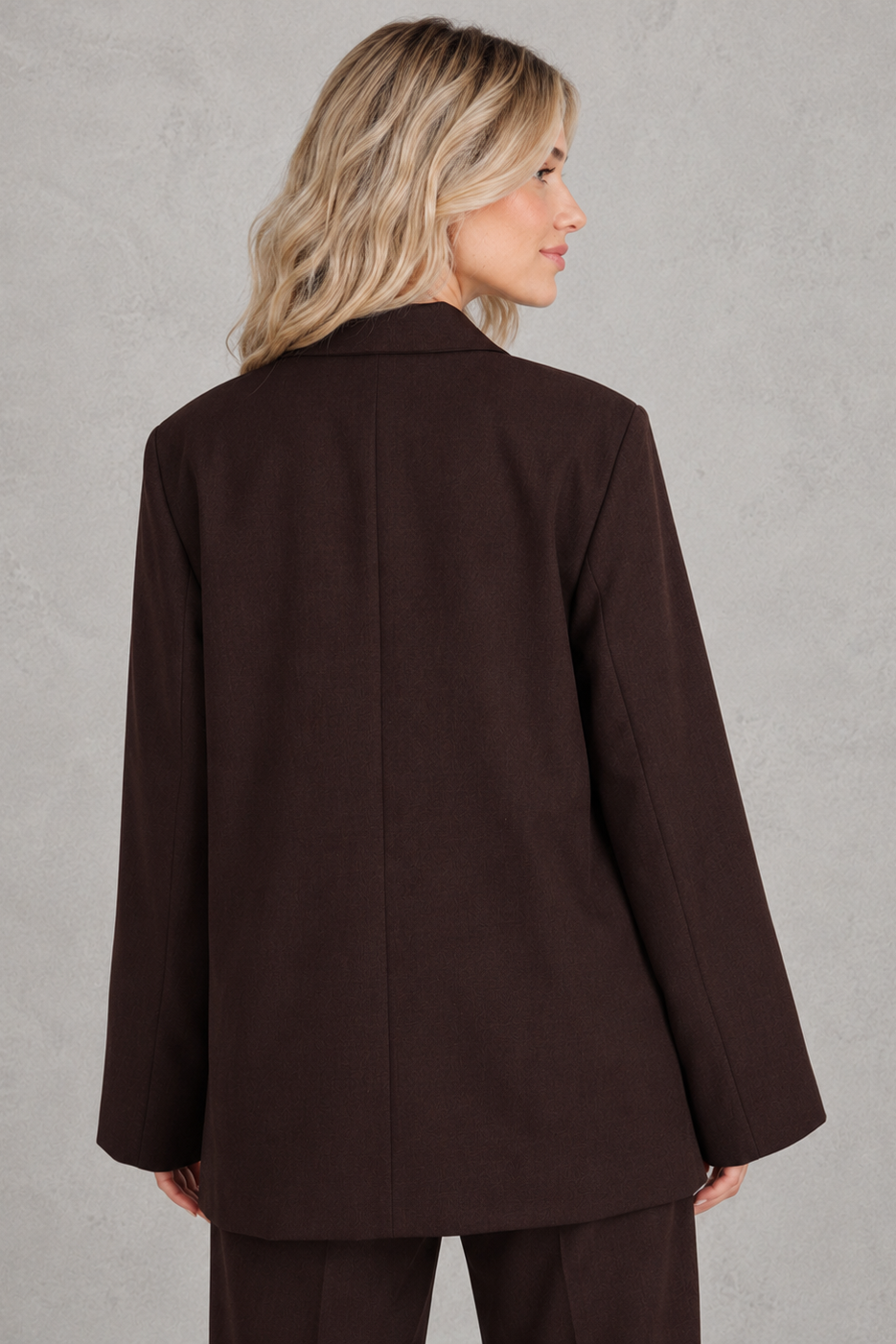 Women’s oversized asymmetrical blazer with a modern button-front closure, structured shoulders, side slits, and a relaxed tailored silhouette.