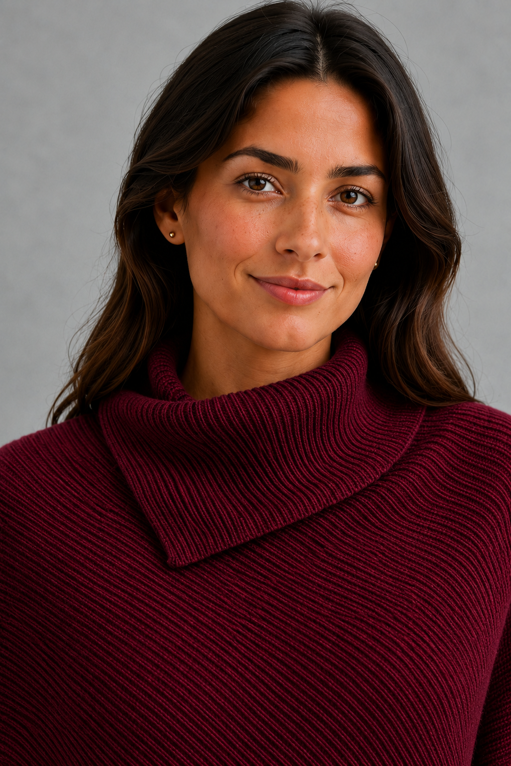 Women’s burgundy oversized batwing sweater with a cozy high neck, long relaxed sleeves, rib-knit texture and modern asymmetrical split hem.