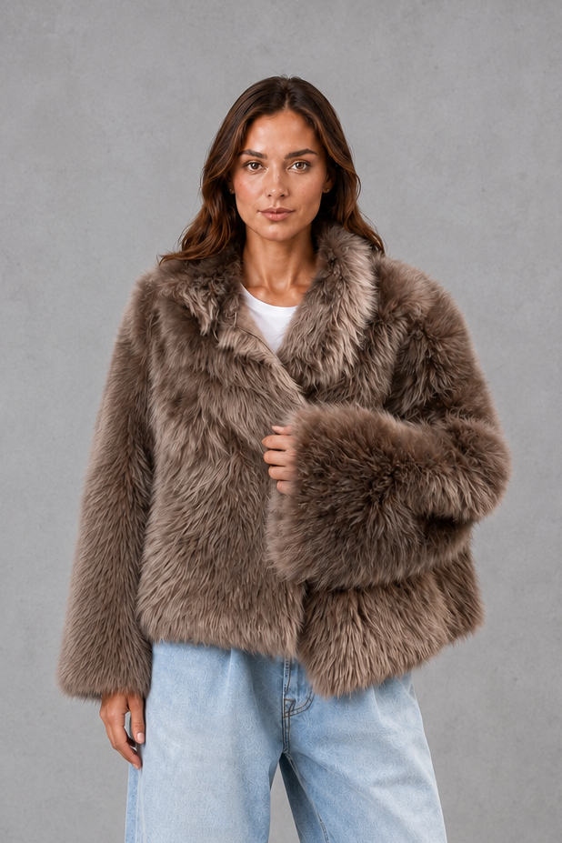 Women’s oversized faux fur coat with a soft plush texture, statement collar and relaxed voluminous silhouette for elegant cold-weather styling.