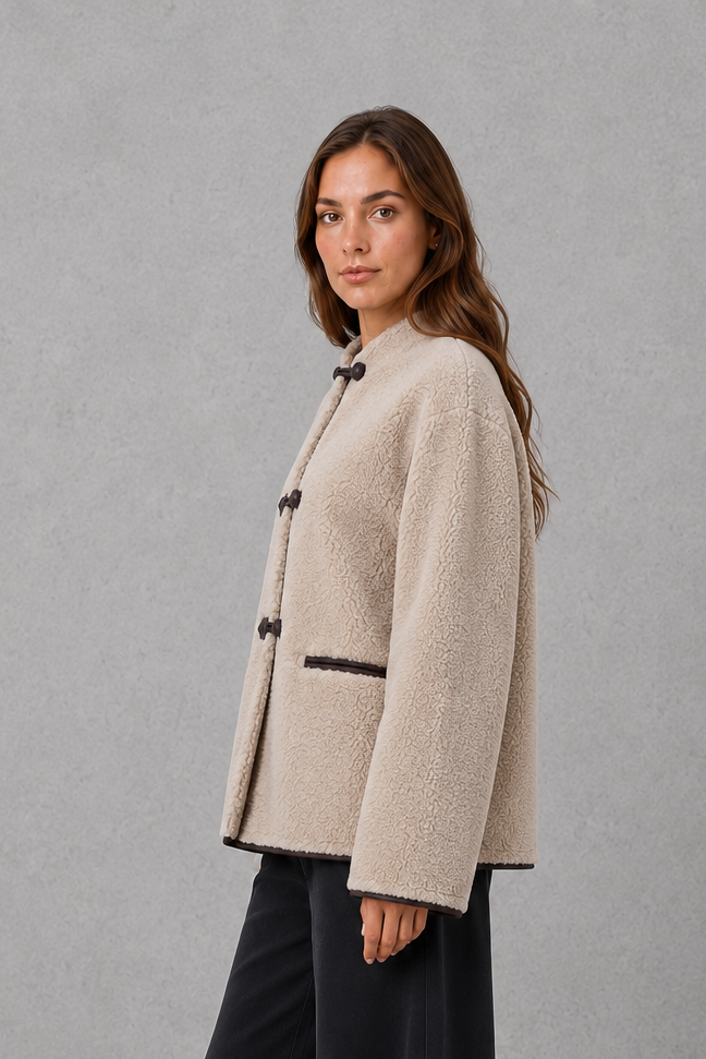 Women’s oversized faux fur toggle jacket with a soft plush texture, contrast trim, classic toggle closures, and two functional front pockets.