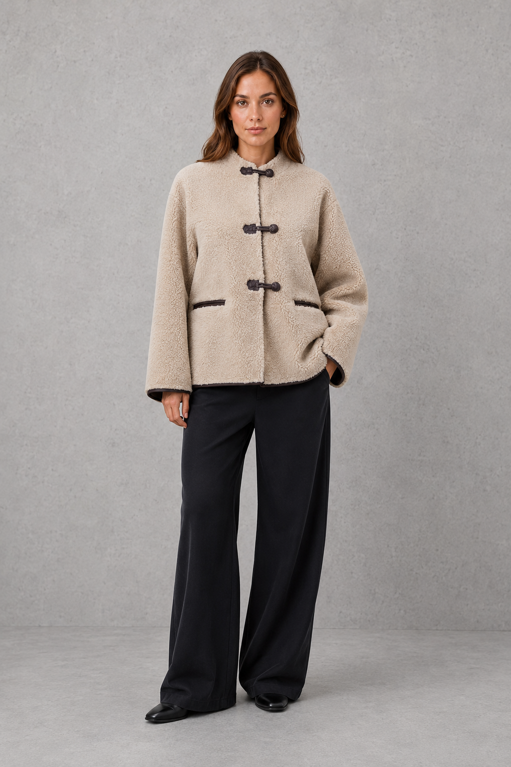Women’s oversized faux fur toggle jacket with a soft plush texture, contrast trim, classic toggle closures, and two functional front pockets.