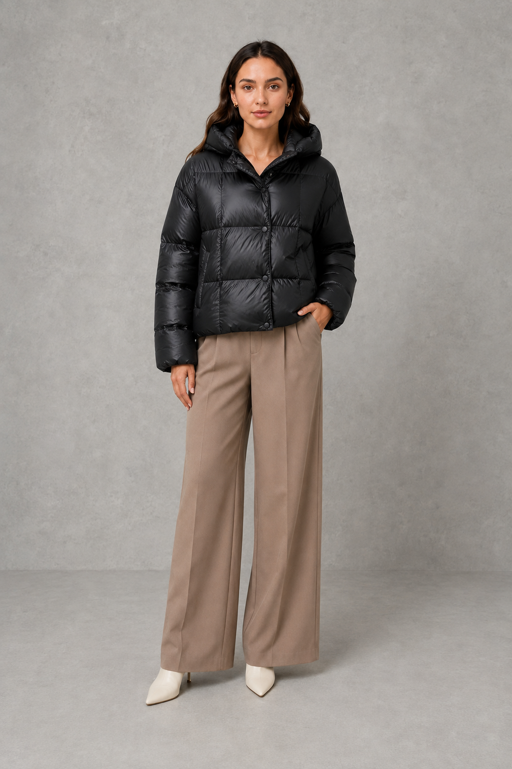 Women’s oversized hooded puffer jacket with generous padding, a large protective hood, high collar and wide long sleeves for cozy cold-weather coverage.