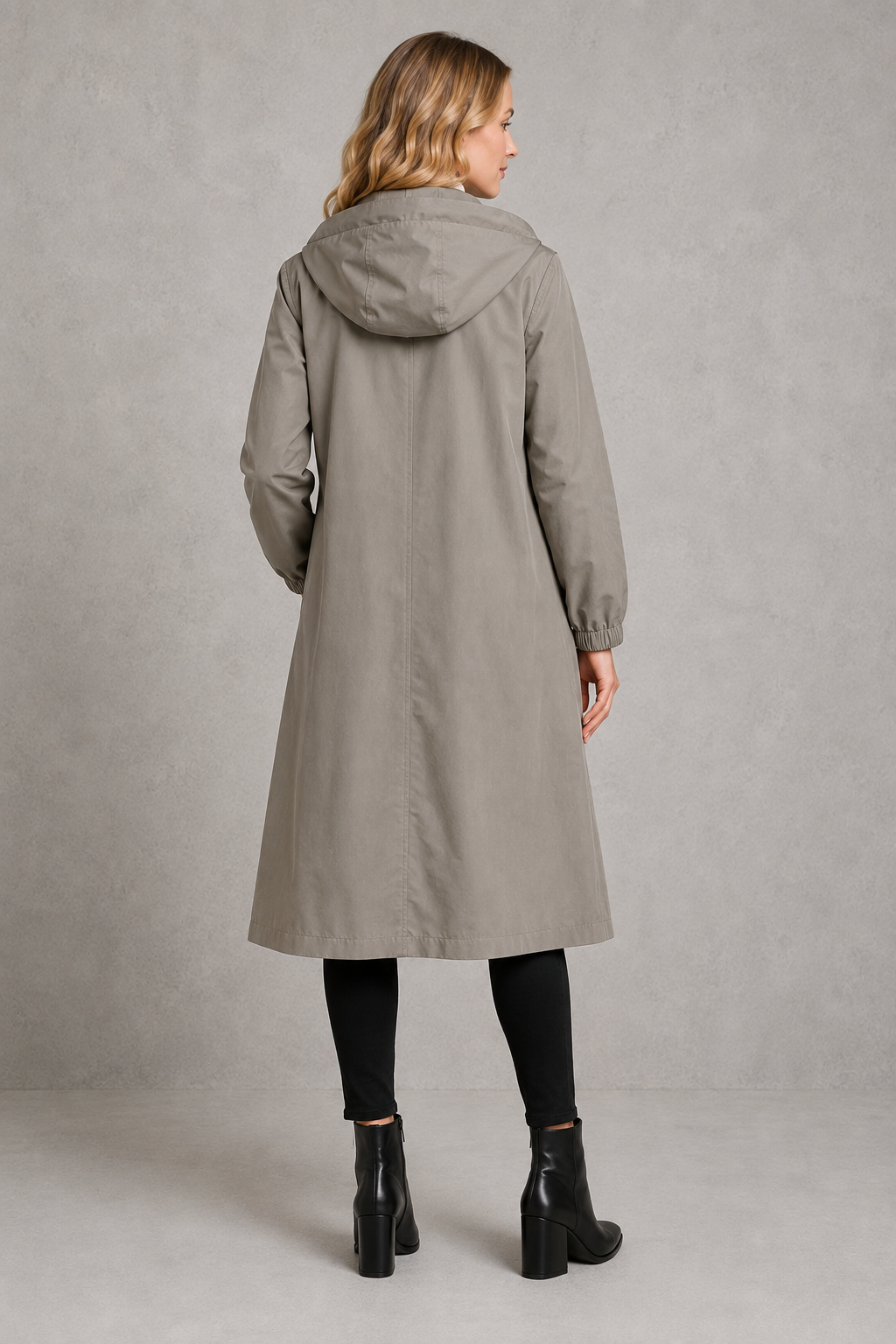 Women’s oversized hooded rain trench with a relaxed longline silhouette, adjustable drawstring hood and lightweight water-repellent finish.