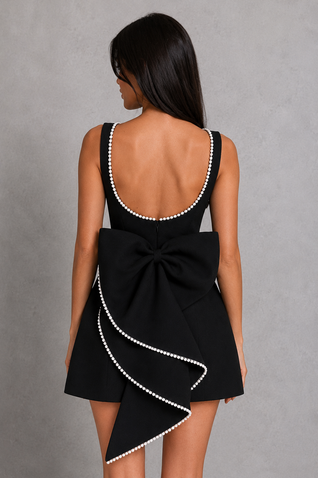 Women's pearl trim mini dress featuring a high boat neckline, fitted crepe bodice with panelled seams, voluminous bubble skirt, curved pearl-trim back, and detachable pearl-adorned bow for parties and special occasions.