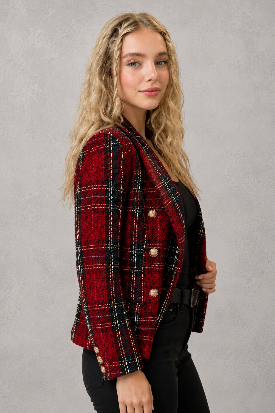 Women’s plaid tweed blazer with a double-breasted front, structured lapel collar, textured woven finish, and tailored silhouette.