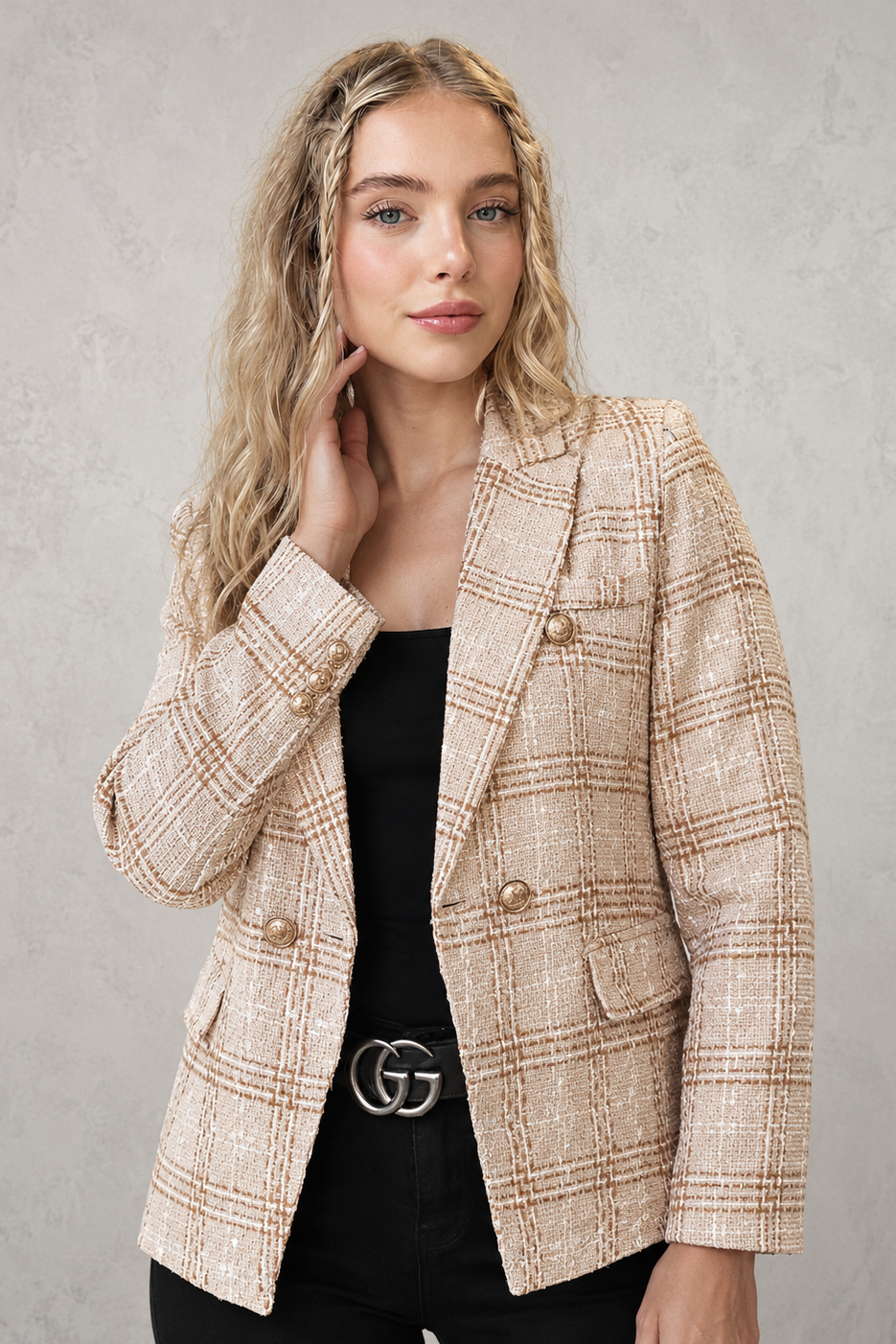 Women’s plaid tweed blazer with a double-breasted front, structured lapel collar, textured woven finish, and tailored silhouette.