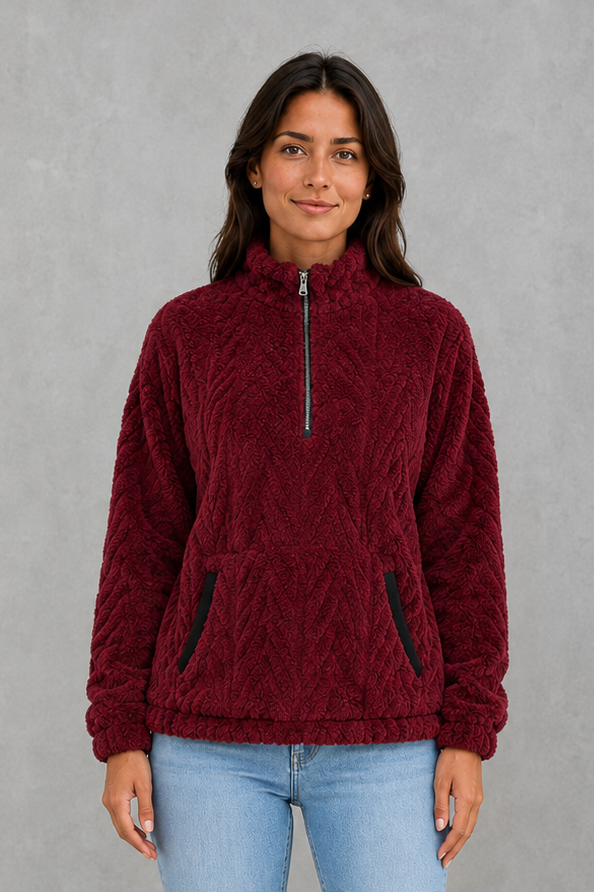 Women’s plush half-zip fleece pullover with a high stand neckline, soft fleece texture, two front pockets, long sleeves, and elasticized cuffs.