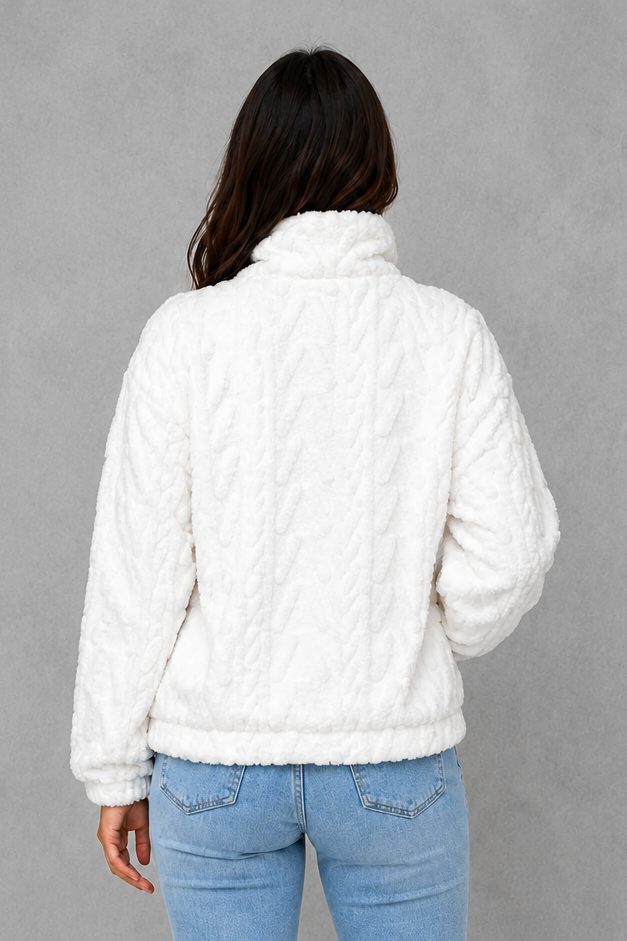 Women’s plush half-zip fleece pullover with a high stand neckline, soft fleece texture, two front pockets, long sleeves, and elasticized cuffs.