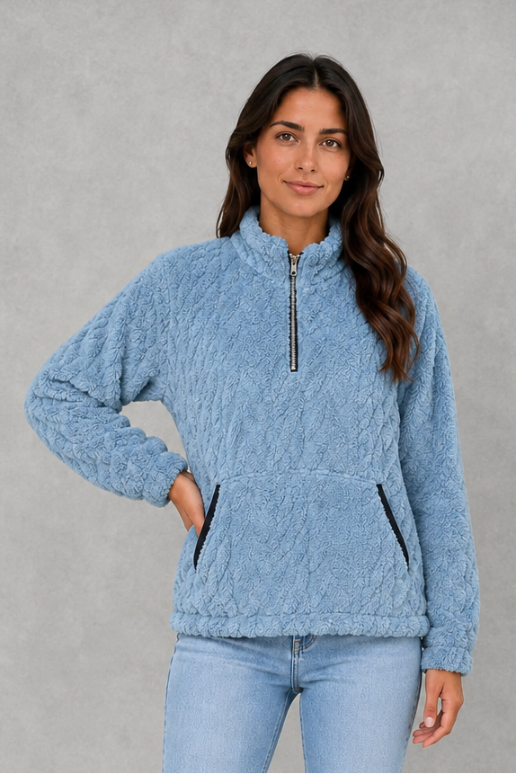 Women’s plush half-zip fleece pullover with a high stand neckline, soft fleece texture, two front pockets, long sleeves, and elasticized cuffs.