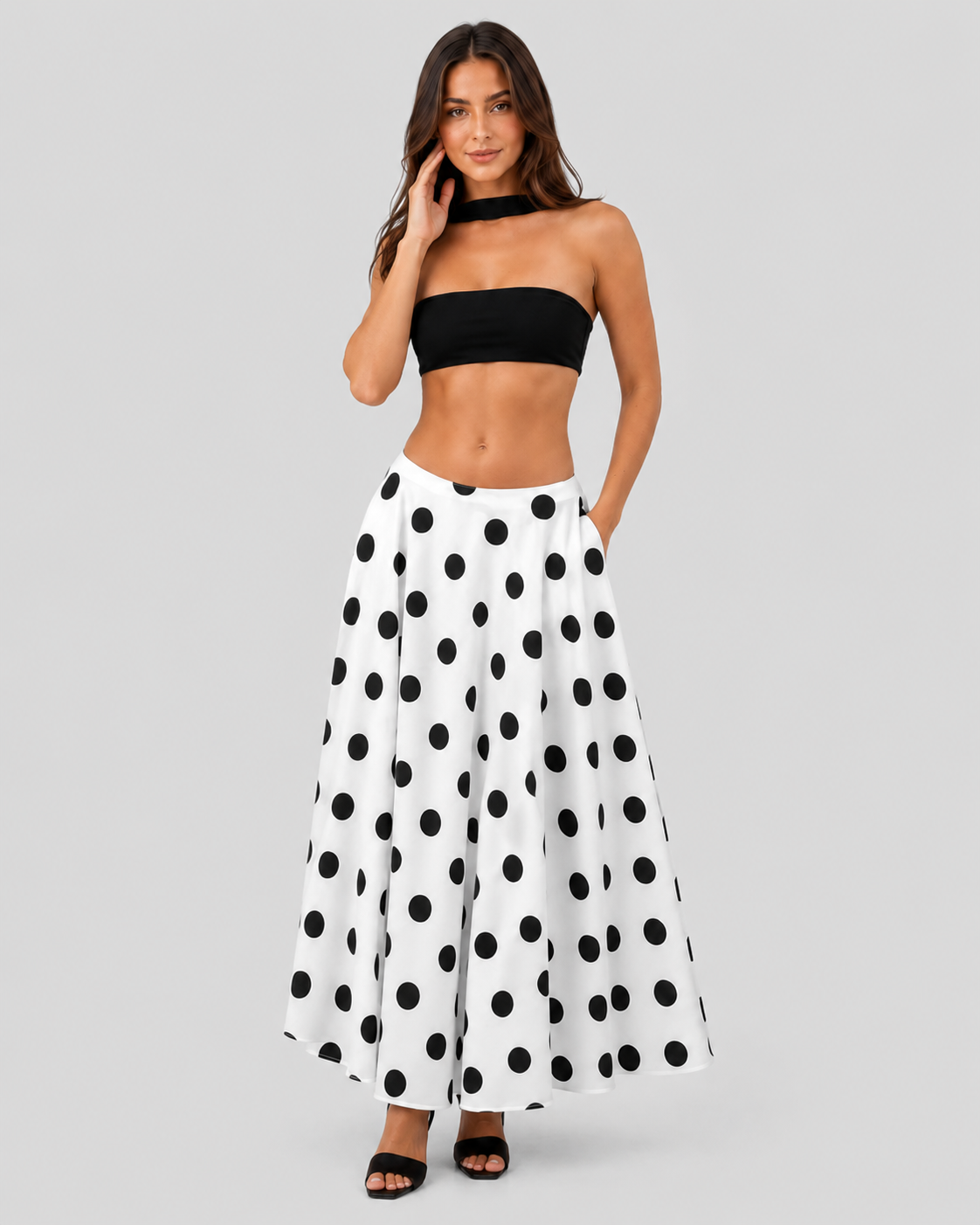 Women’s flowy maxi skirt featuring a classic black-and-white polka dot pattern, lightweight breathable fabric, and a relaxed silhouette for comfortable everyday wear.