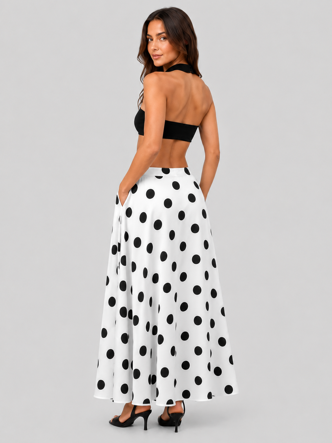 Women’s flowy maxi skirt featuring a classic black-and-white polka dot pattern, lightweight breathable fabric, and a relaxed silhouette for comfortable everyday wear.