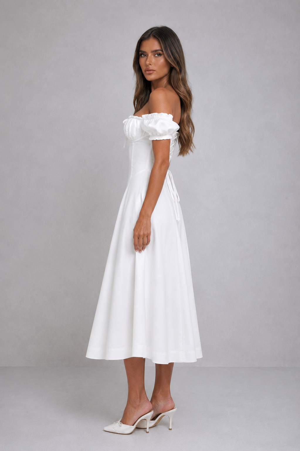 Women’s puff sleeve midi dress with ruched underwired bust, cinched waist, adjustable lace-up back, and flowing dropped-waist skirt.