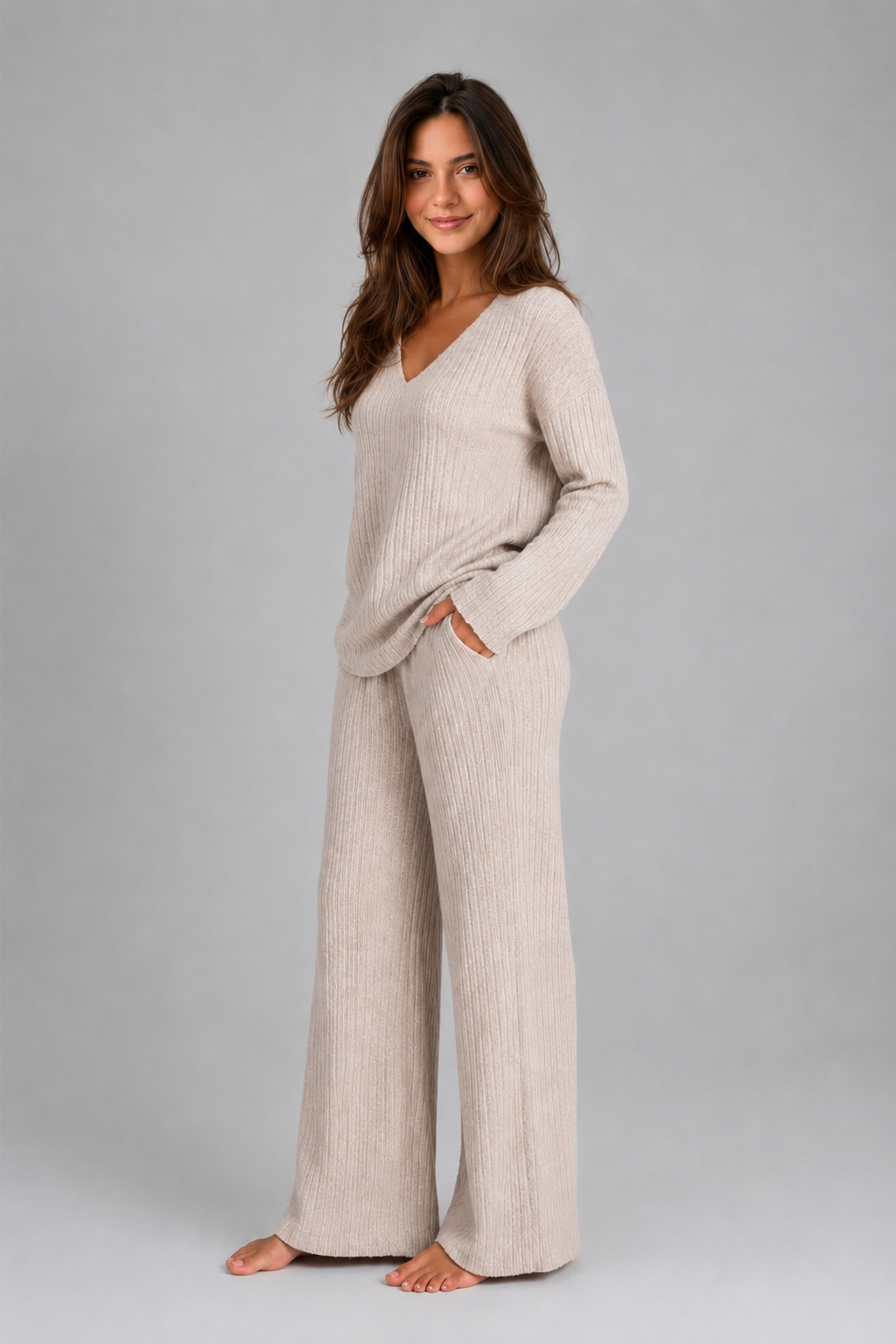 Women’s ribbed knit two-piece lounge set featuring a relaxed V-neck sweater and matching wide-leg pants with a soft, textured finish.