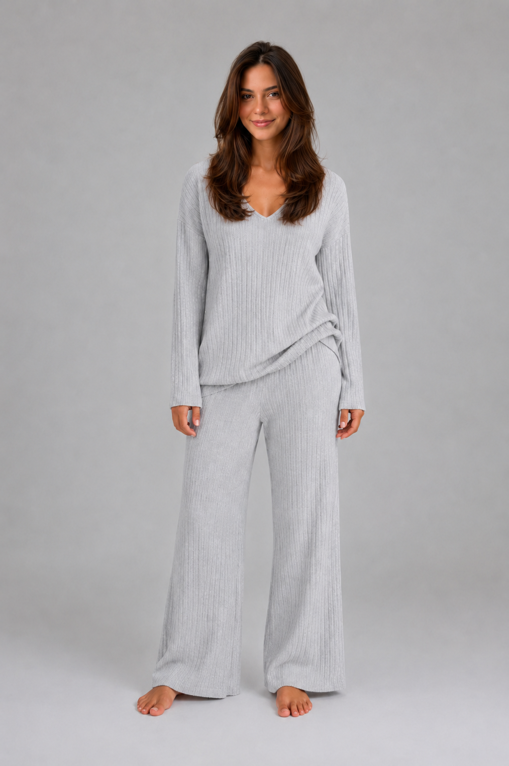 Women’s ribbed knit two-piece lounge set featuring a relaxed V-neck sweater and matching wide-leg pants with a soft, textured finish.