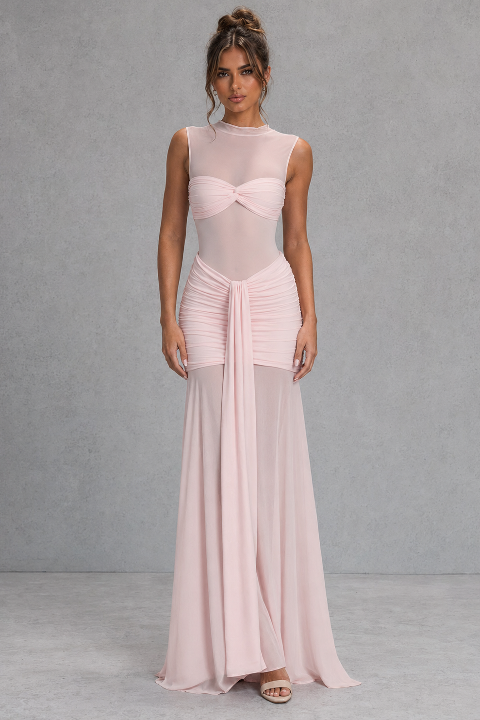 Women's ruched maxi skirt with a V-shaped waistband, slinky jersey upper, sheer mesh hem, and removable floral orchid brooch for evening and special occasion wear.
