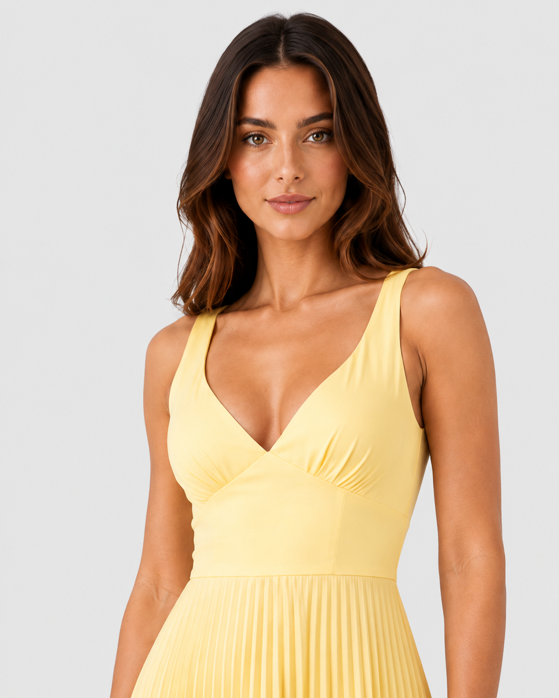 Woman wearing a satin-like maxi dress featuring a twist-front V-neck bodice, defined waist, and finely pleated full-length skirt. The fitted upper silhouette flows into a graceful, movement-friendly skirt for an elegant and sophisticated look.