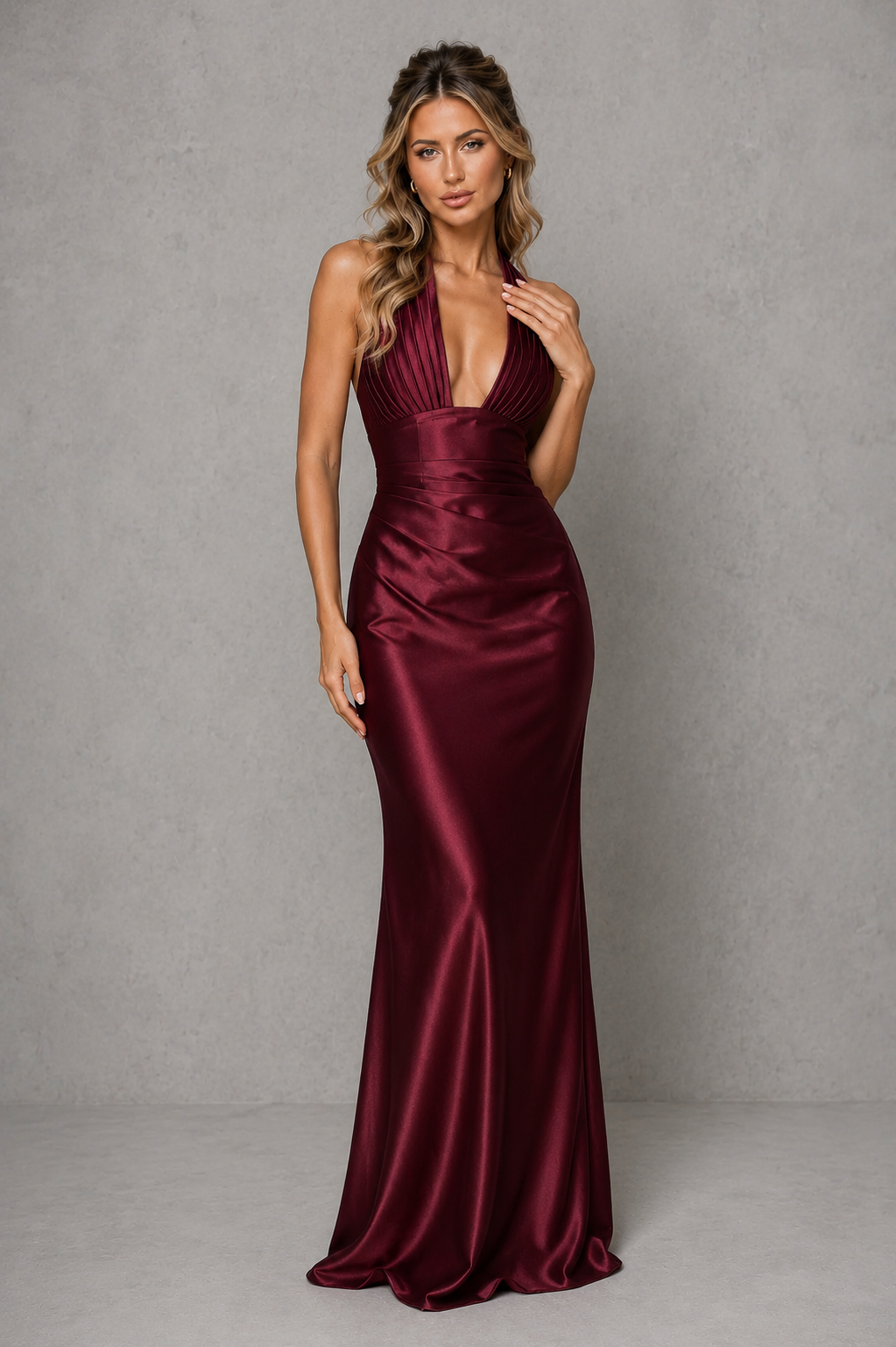Women’s satin halter maxi dress with plunge neckline, pleated cups, structured corset bodice, lace-up back, and flowing bias-cut skirt.