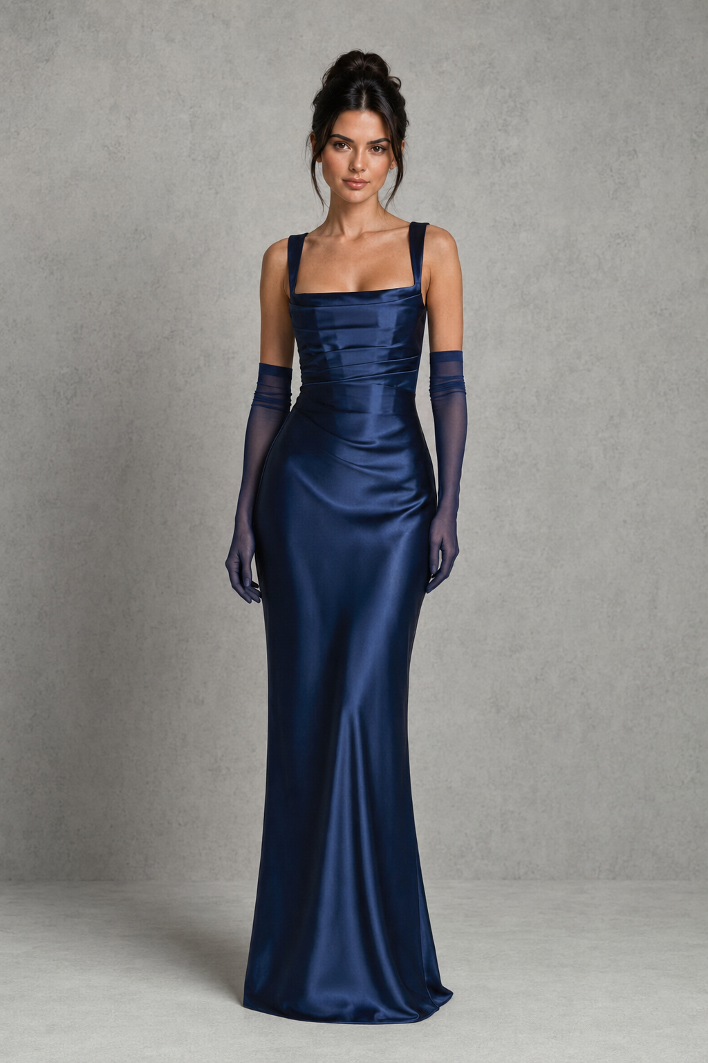 Women's satin maxi dress featuring a structured corset bodice, square neckline, asymmetric pleated detailing, adjustable shoulder straps, and a flowing full-length skirt with a lace-up back, designed for elegant evening events and formal occasions.
