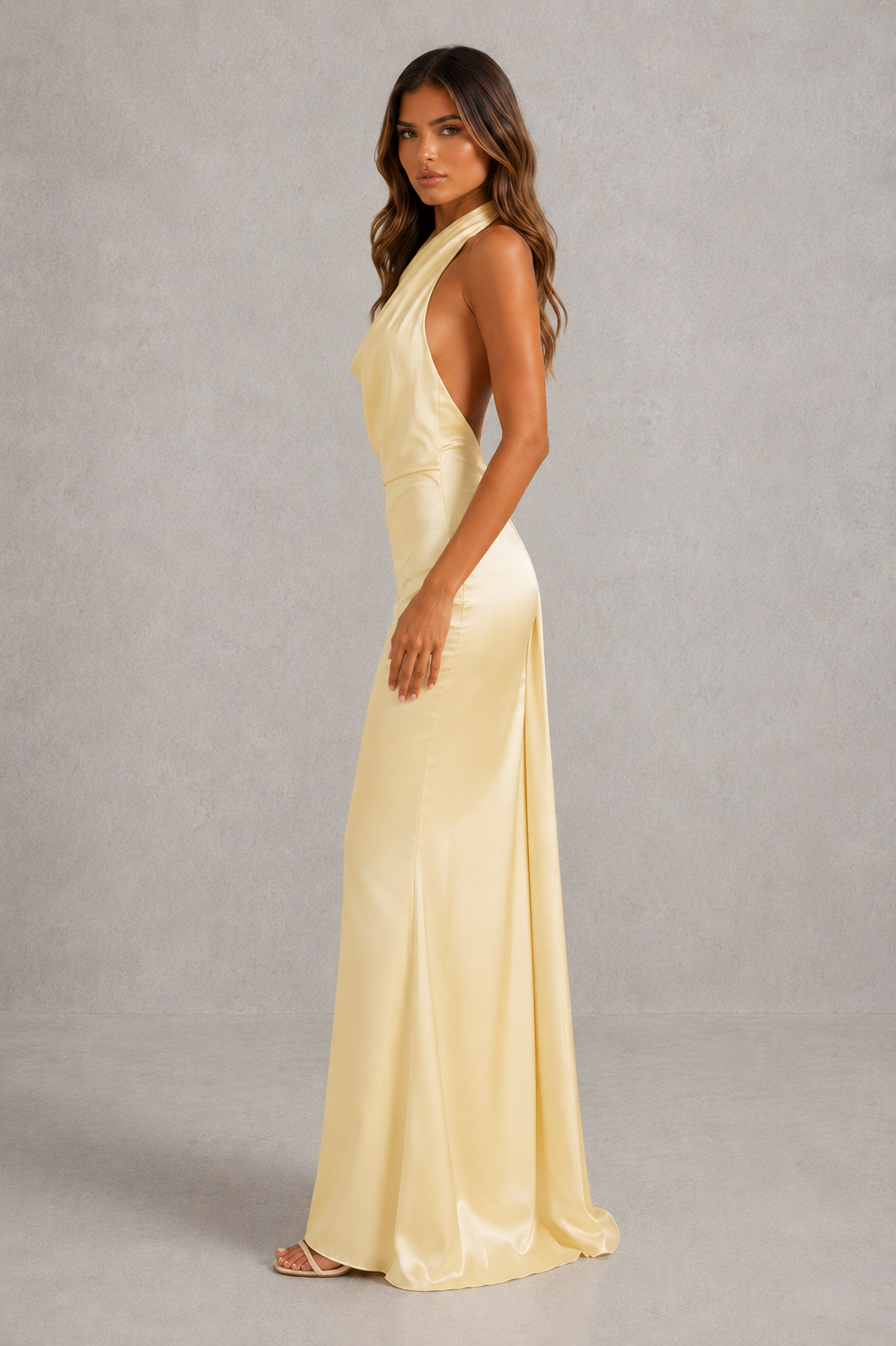 Women’s elegant satin maxi dress with cowl halter neckline, low scoop back, tie-back detail and flowing split skirt for formal evening wear.