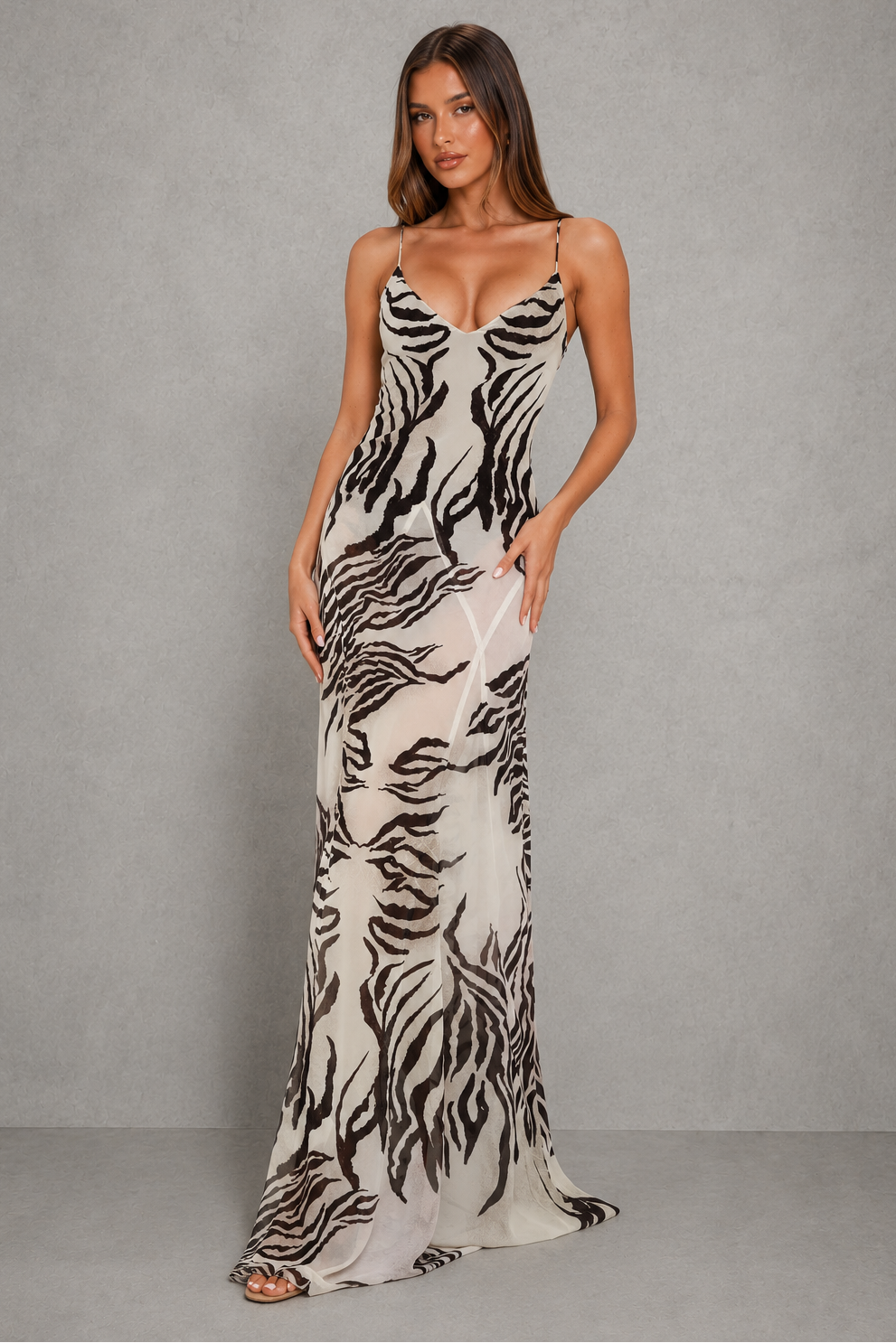 Women’s sheer maxi dress with triangle neckline, thin adjustable straps, built-in lined bodysuit, and flowing sheer overlay.