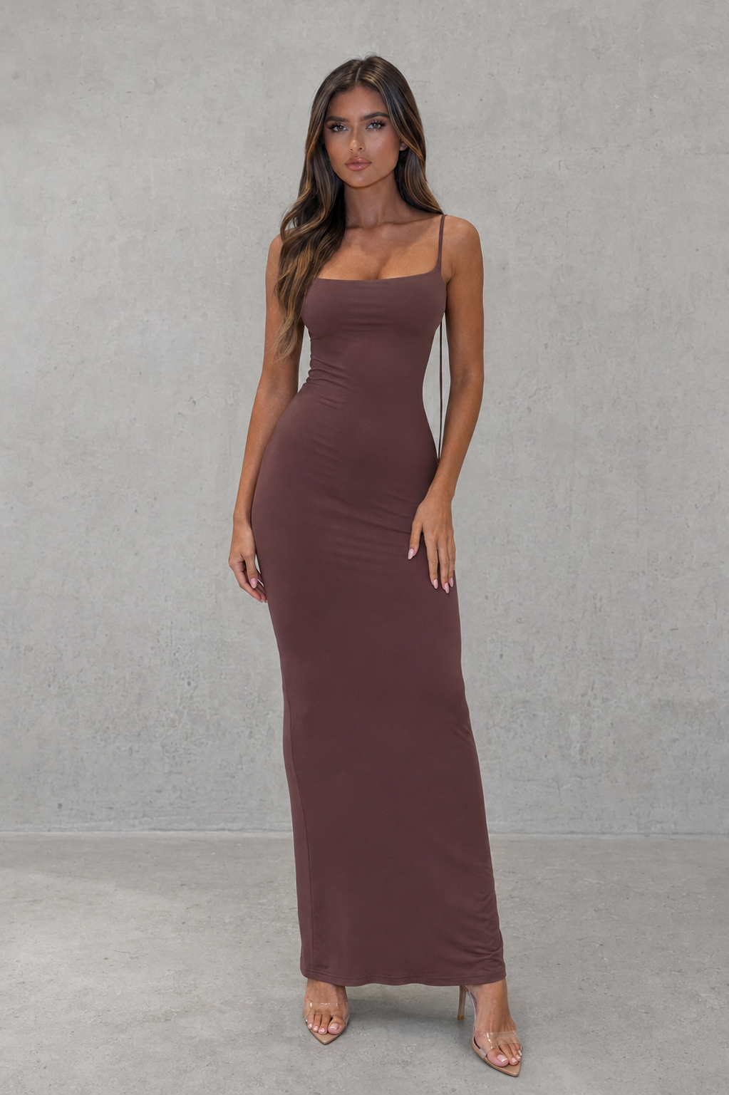Women’s slinky maxi dress with scoop neckline, adjustable tie straps, ultra-low back, ruched detailing, and a figure-hugging silhouette.