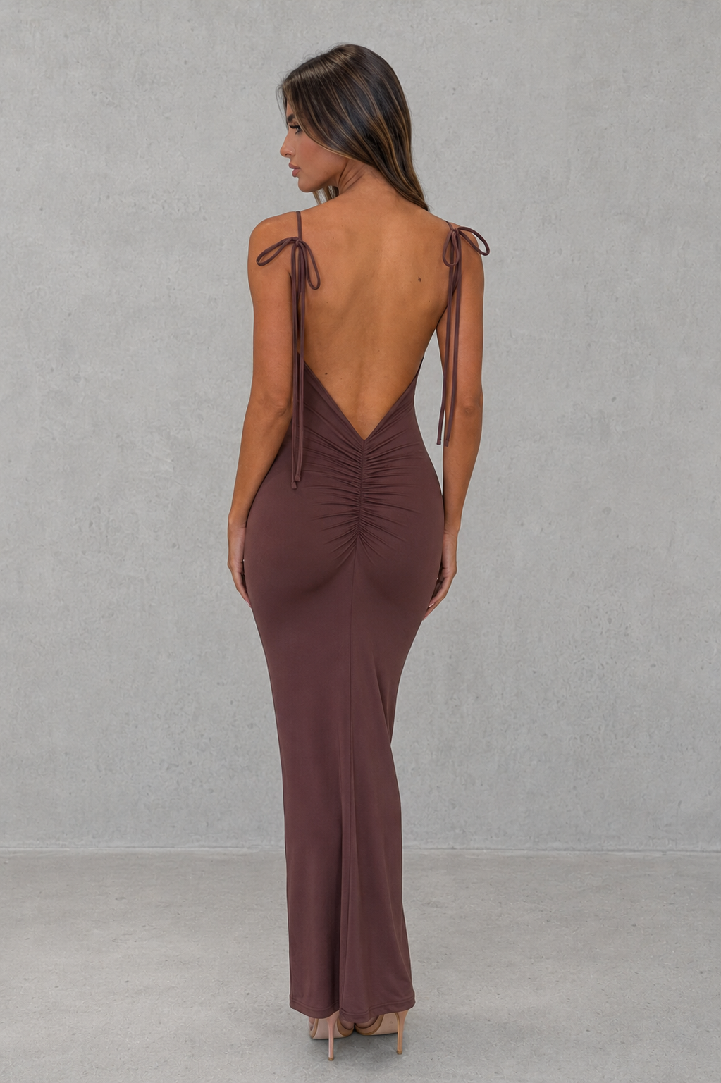 Women’s slinky maxi dress with scoop neckline, adjustable tie straps, ultra-low back, ruched detailing, and a figure-hugging silhouette.