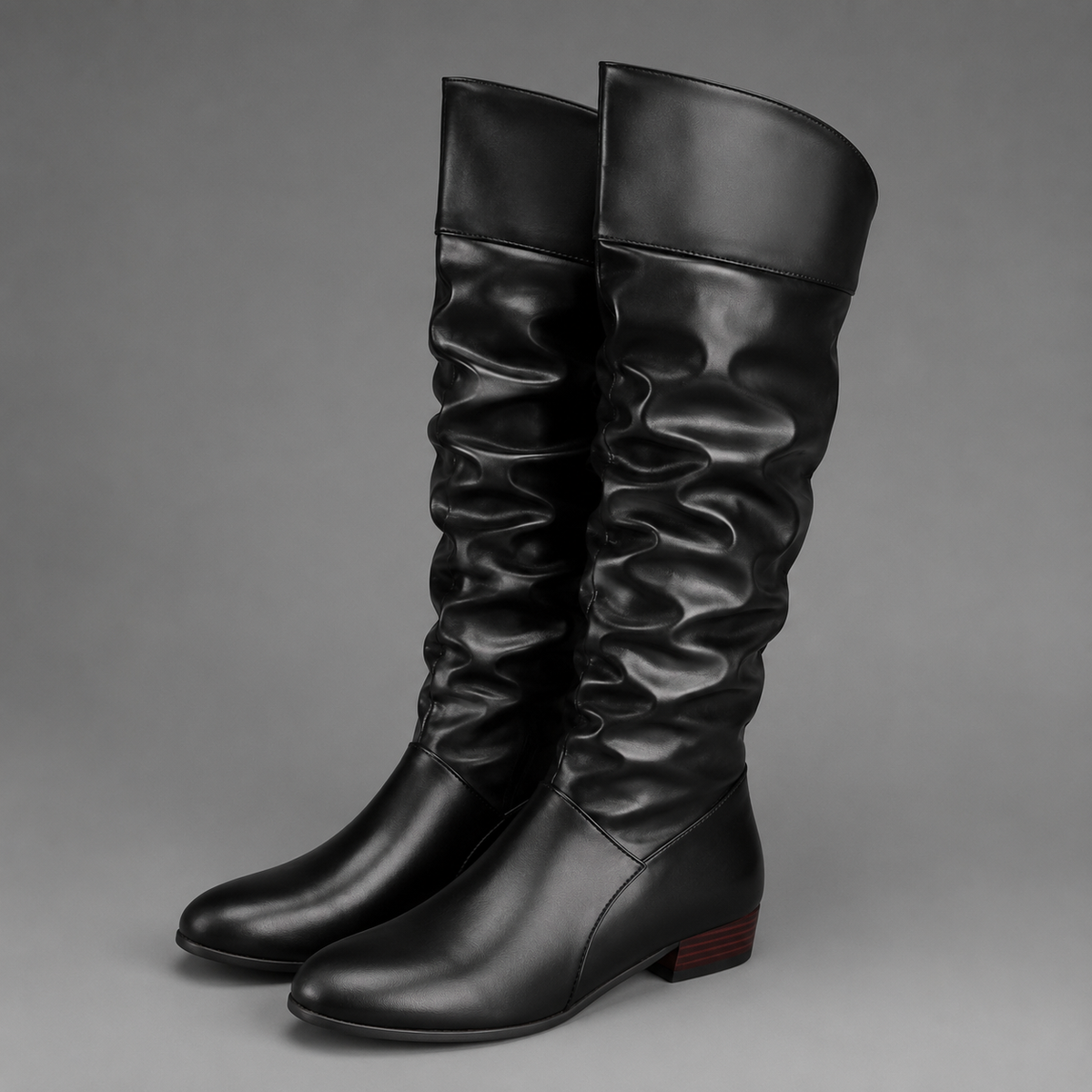 Women’s slouch knee-high boots with a smooth PU leather-look finish, relaxed shaft, low block heel, and durable rubber outsole.