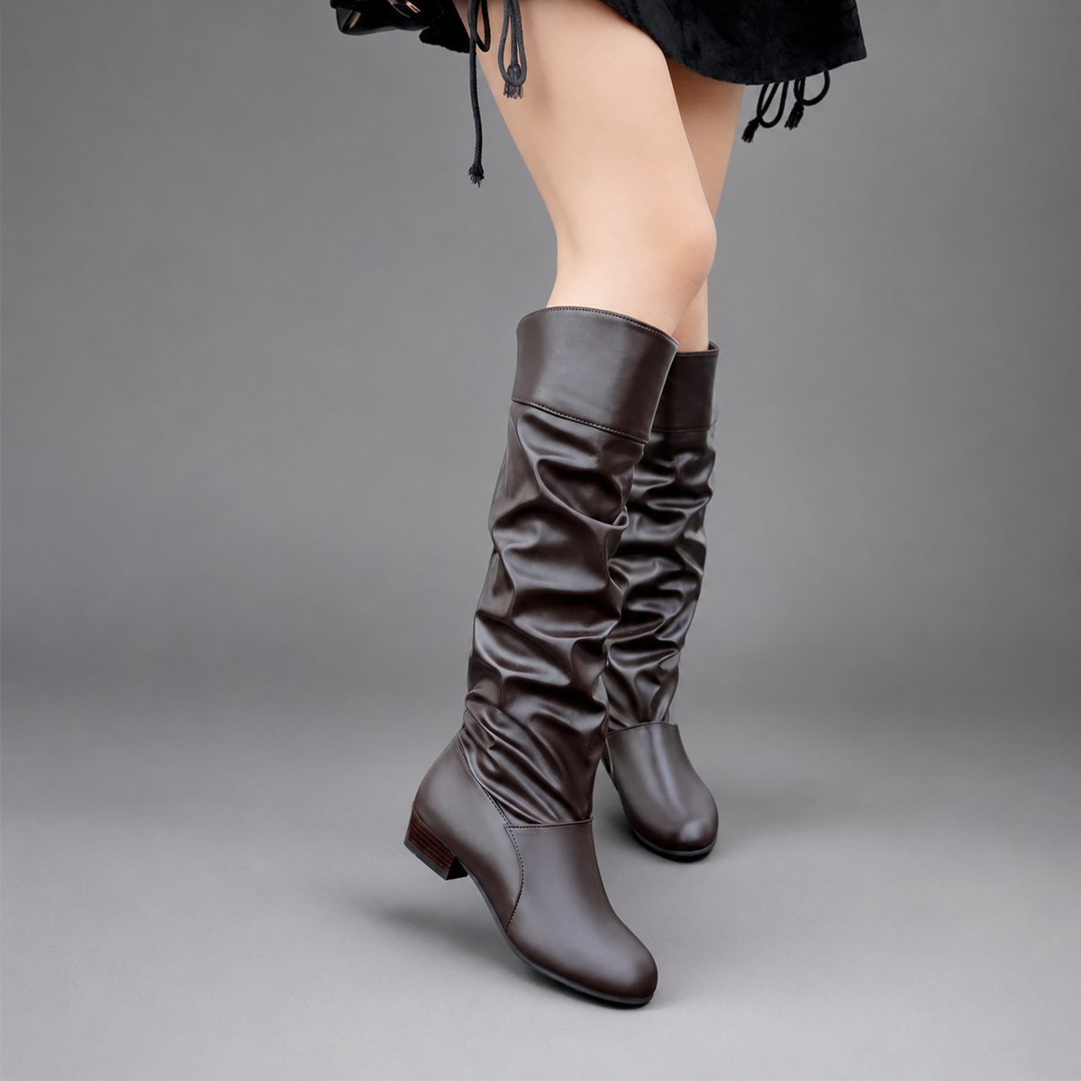 Women’s slouch knee-high boots with a smooth PU leather-look finish, relaxed shaft, low block heel, and durable rubber outsole.