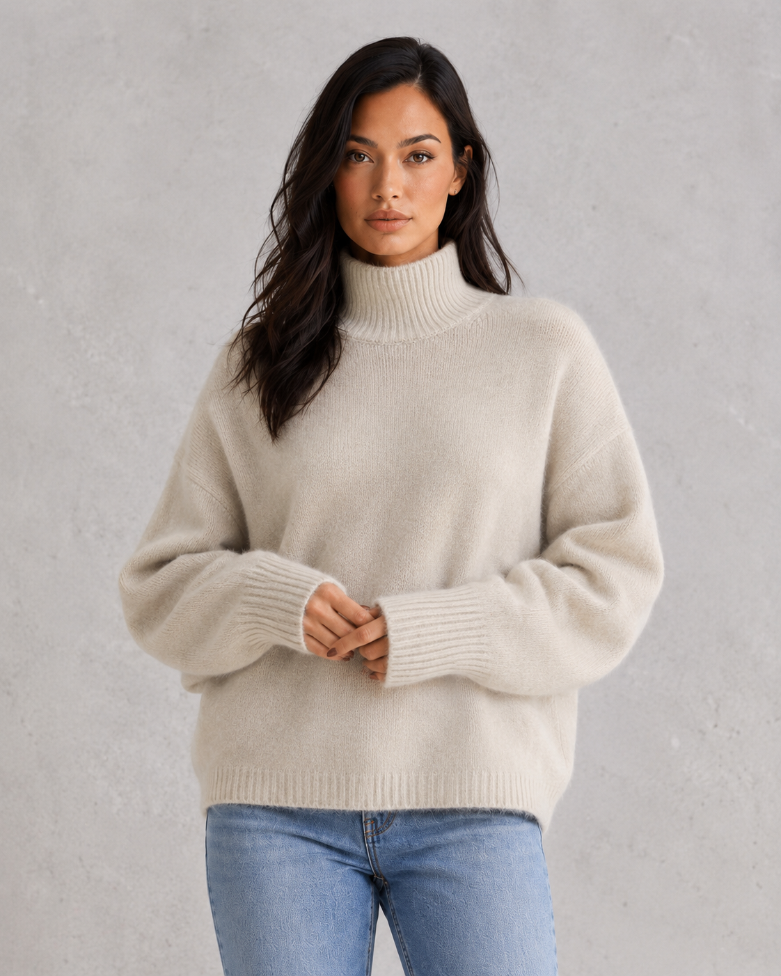 Women's soft cashmere turtleneck sweater with relaxed fit and elegant cold-weather styling.
