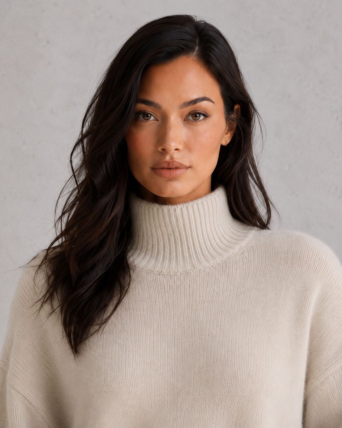 Women's soft cashmere turtleneck sweater with relaxed fit and elegant cold-weather styling.