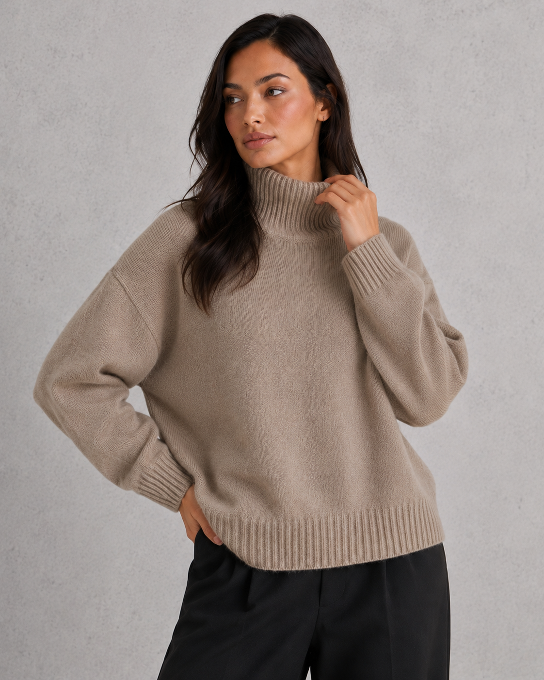 Women's soft cashmere turtleneck sweater with relaxed fit and elegant cold-weather styling.