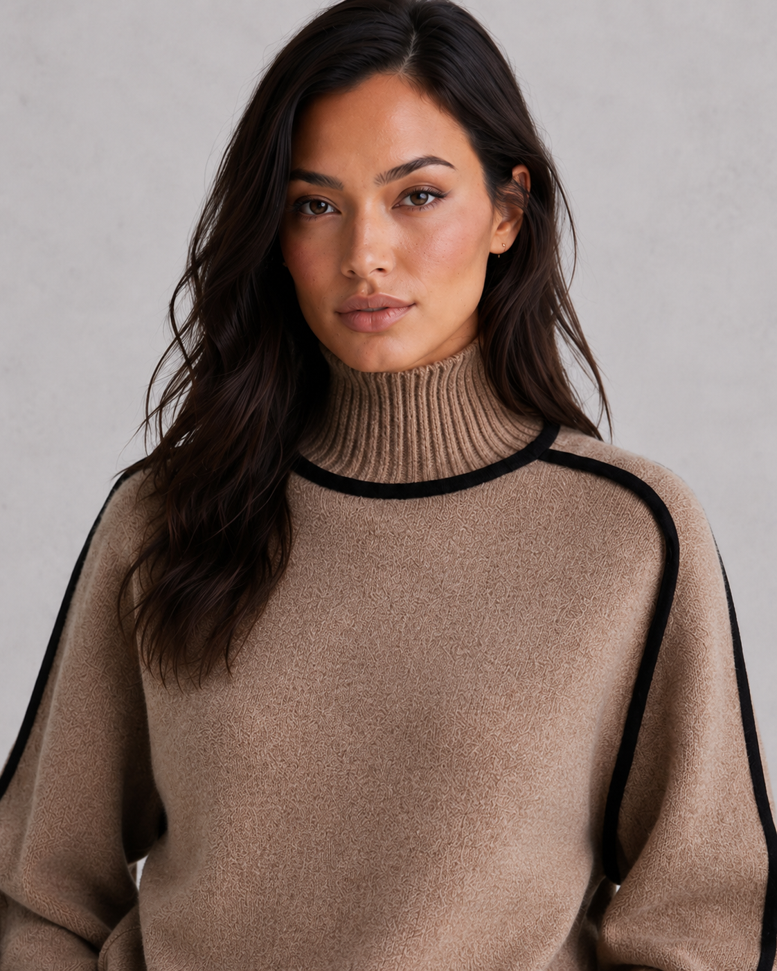 Woman wearing a soft merino wool turtleneck sweater with a relaxed fit and elegant winter styling.