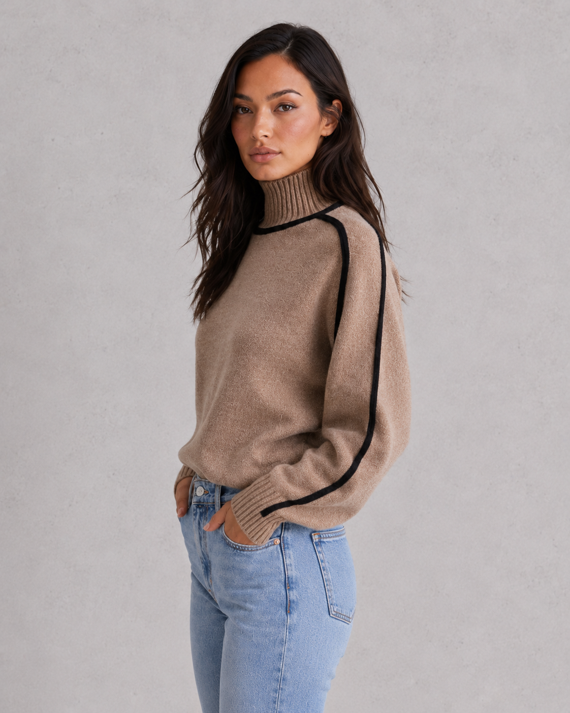 Woman wearing a soft merino wool turtleneck sweater with a relaxed fit and elegant winter styling.