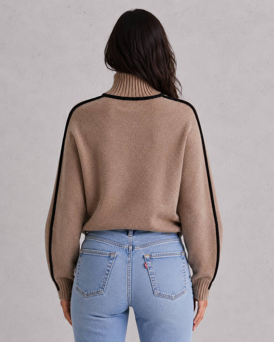 Woman wearing a soft merino wool turtleneck sweater with a relaxed fit and elegant winter styling.