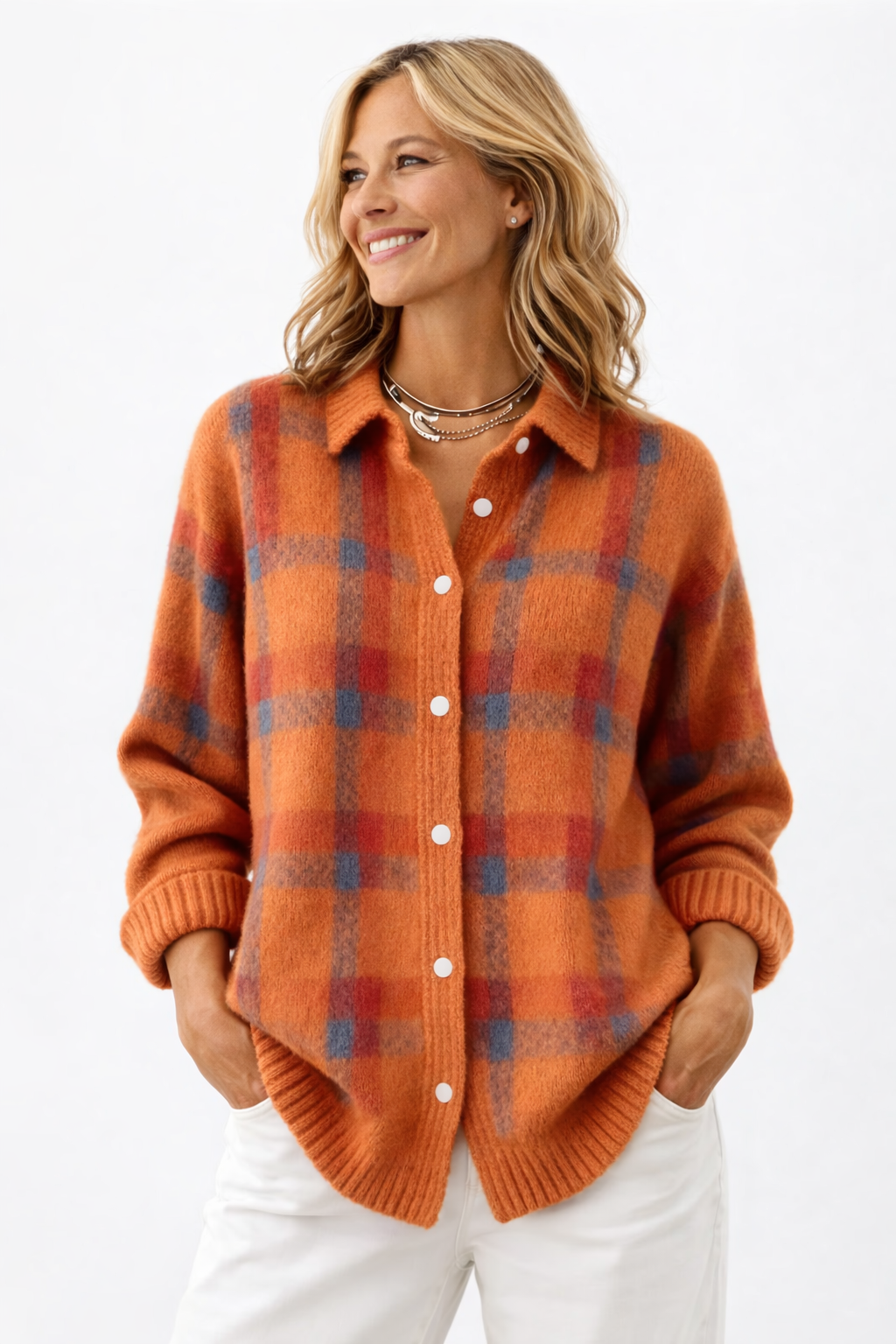 Woman wearing an orange plaid sweater on a white background