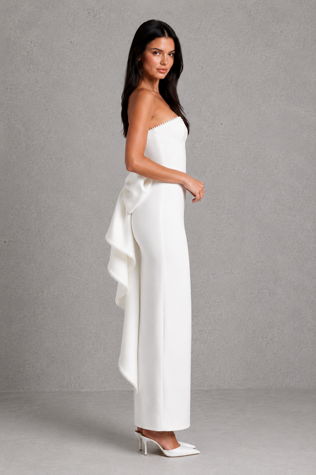 Women's strapless maxi dress in structured crepe featuring a pearl-trimmed neckline, fitted bodice, defined waist, sleek column skirt, centre back split, and detachable oversized bow for elegant evening and formal occasions.