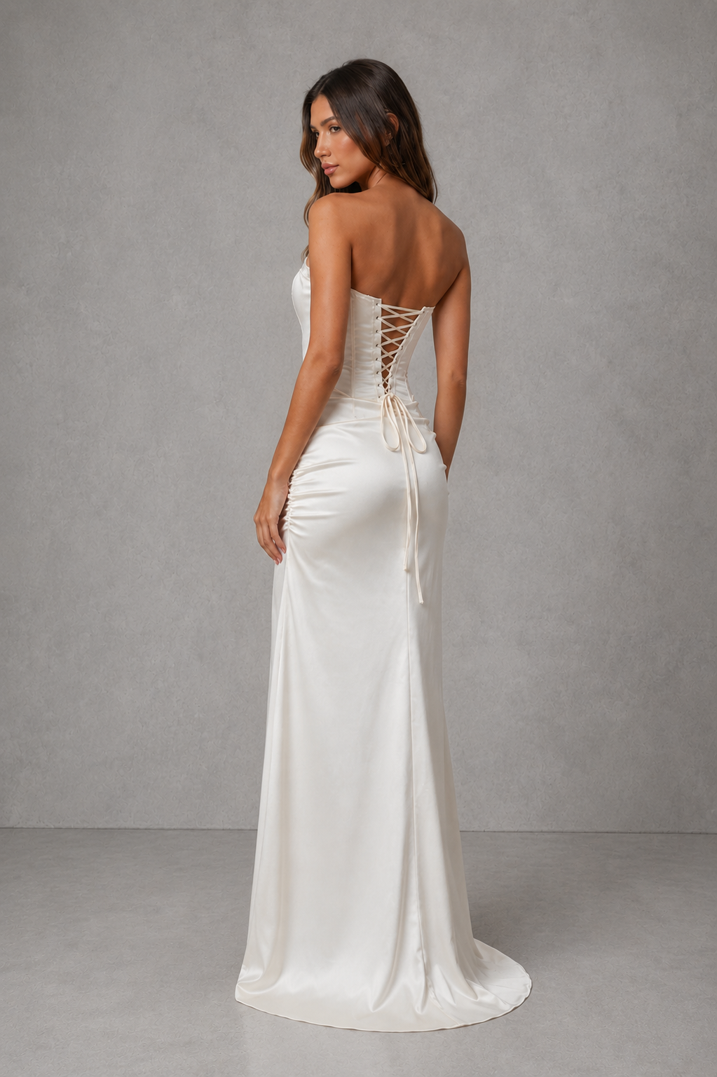 Women’s strapless satin corset maxi dress with a structured bodice, pleated detailing, fitted waist, flowing skirt, and elegant high slit.