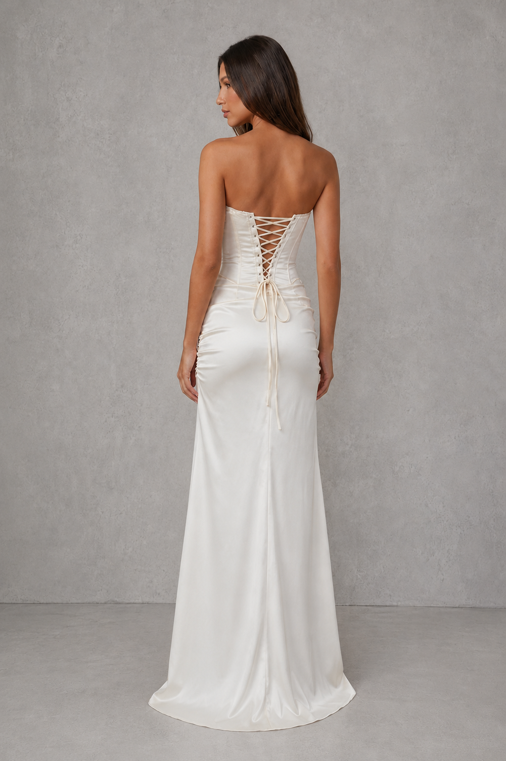 Women’s strapless satin corset maxi dress with a structured bodice, pleated detailing, fitted waist, flowing skirt, and elegant high slit.