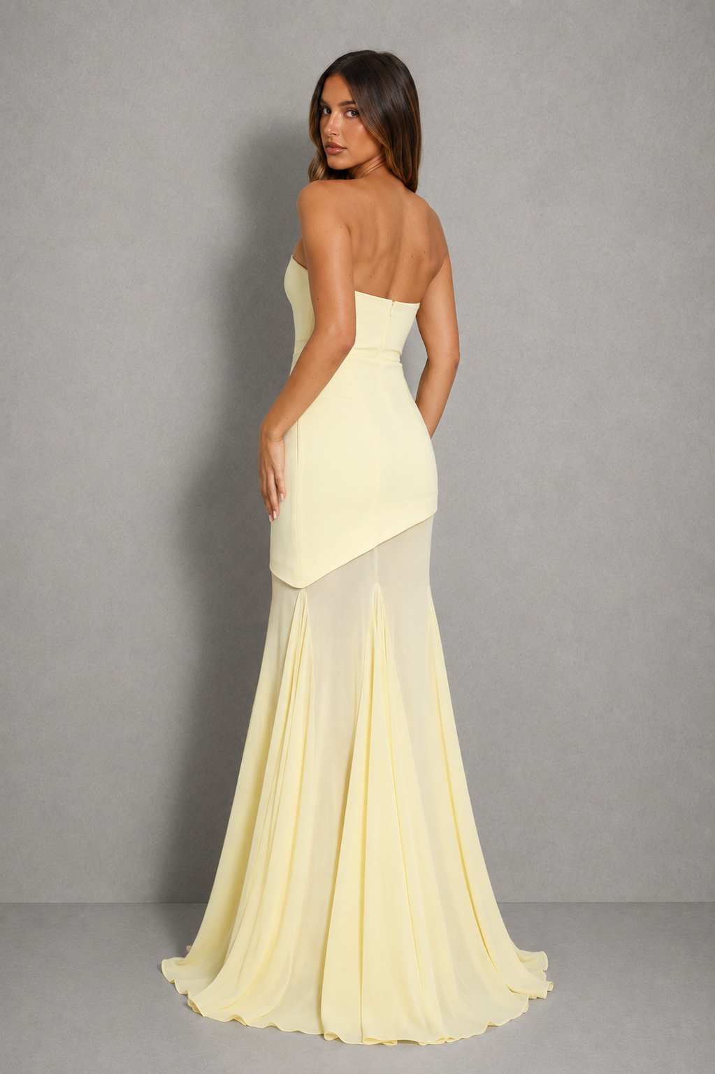 Women’s strapless maxi dress with a fitted mini-length lining, flowing sheer overlay, and elegant asymmetric hem for formal occasions.