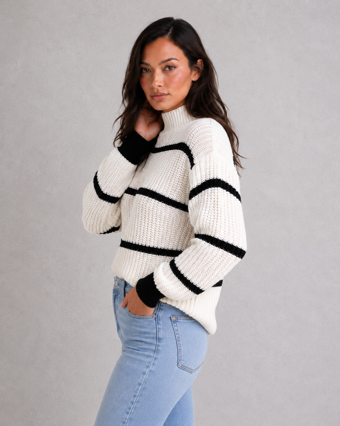 Women's striped knit turtleneck sweater with relaxed fit, lantern sleeves, and mock neck in a timeless autumn-winter design.