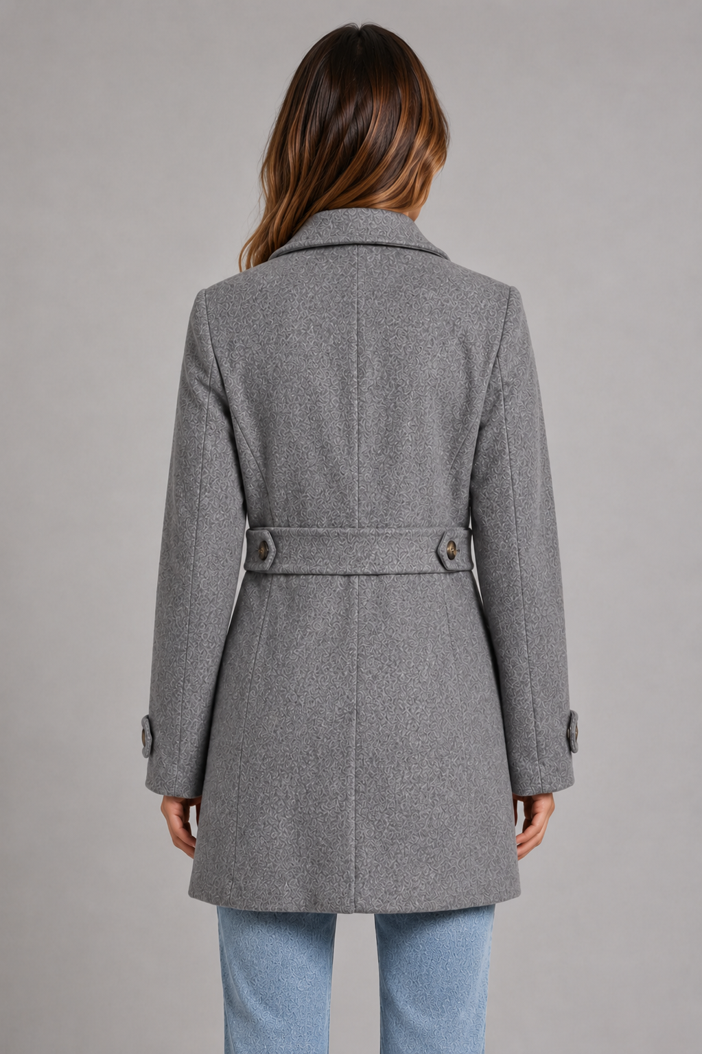 Women’s tailored longline coat with classic collar, button-front closure, waist-defining seams, decorative button tabs, and adjustable cuffs.