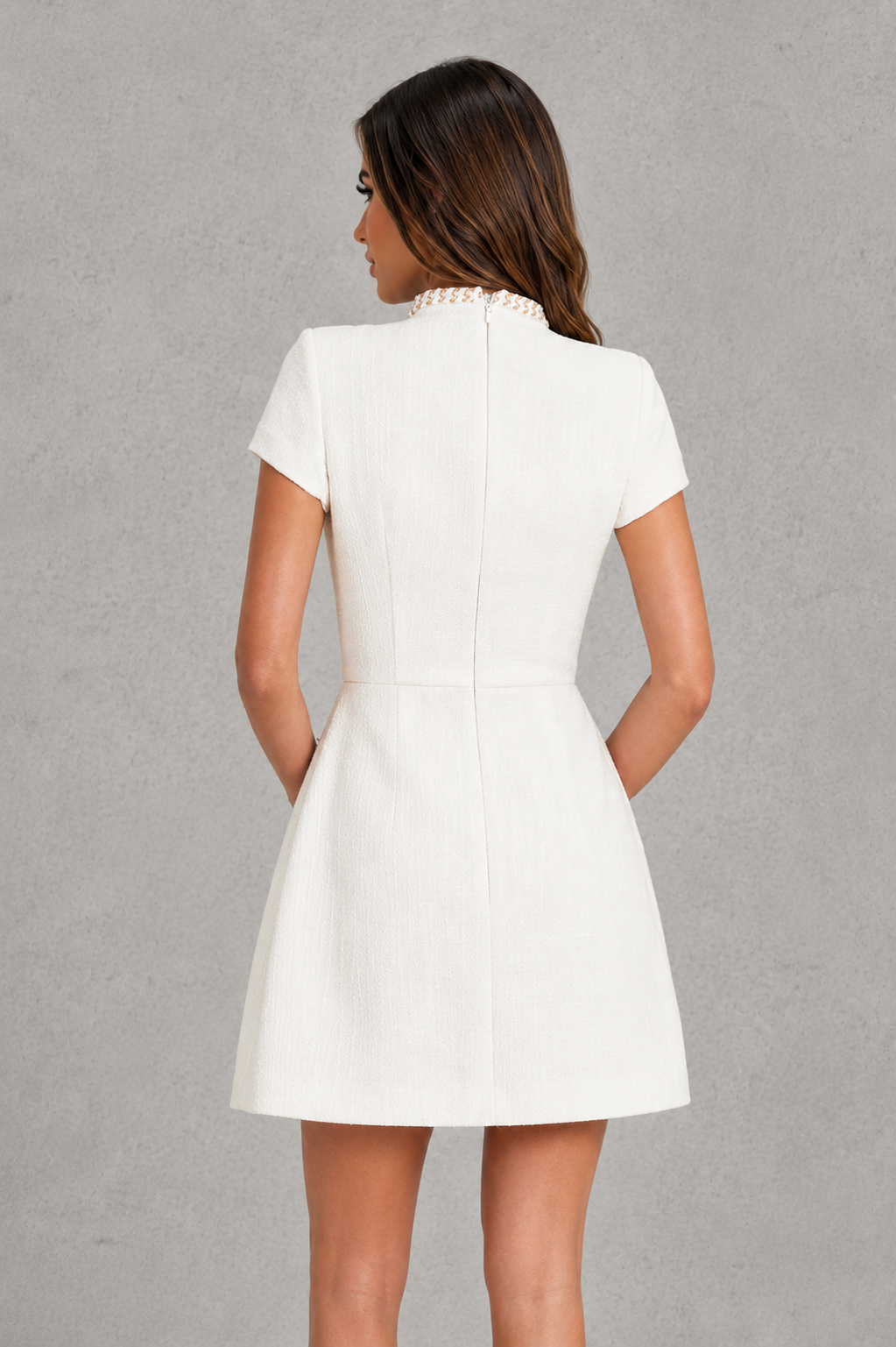 Women's textured tweed mini dress featuring a high neckline, fitted bodice, figure-enhancing seam detailing, open keyhole back with button closure, and a voluminous bubble skirt for elegant party and special occasion wear.